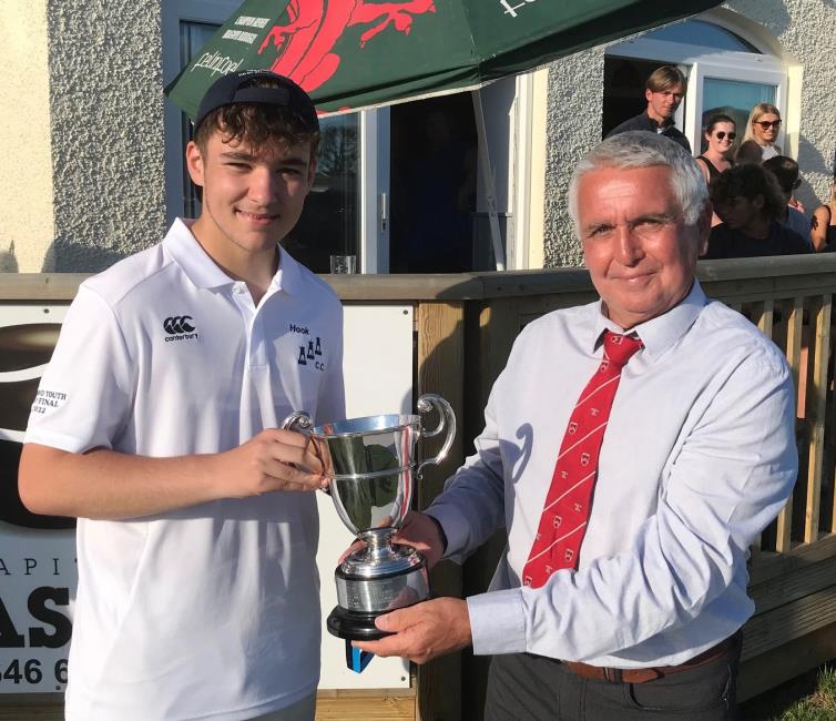 Carew President Martin Cole presents the Ormond Youth Cup to Owen Phelps